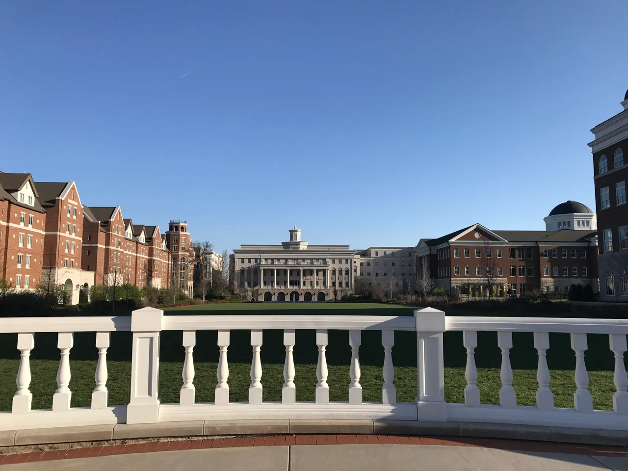 Belmont University campus buildings and lawn viewed across a white balustrade.