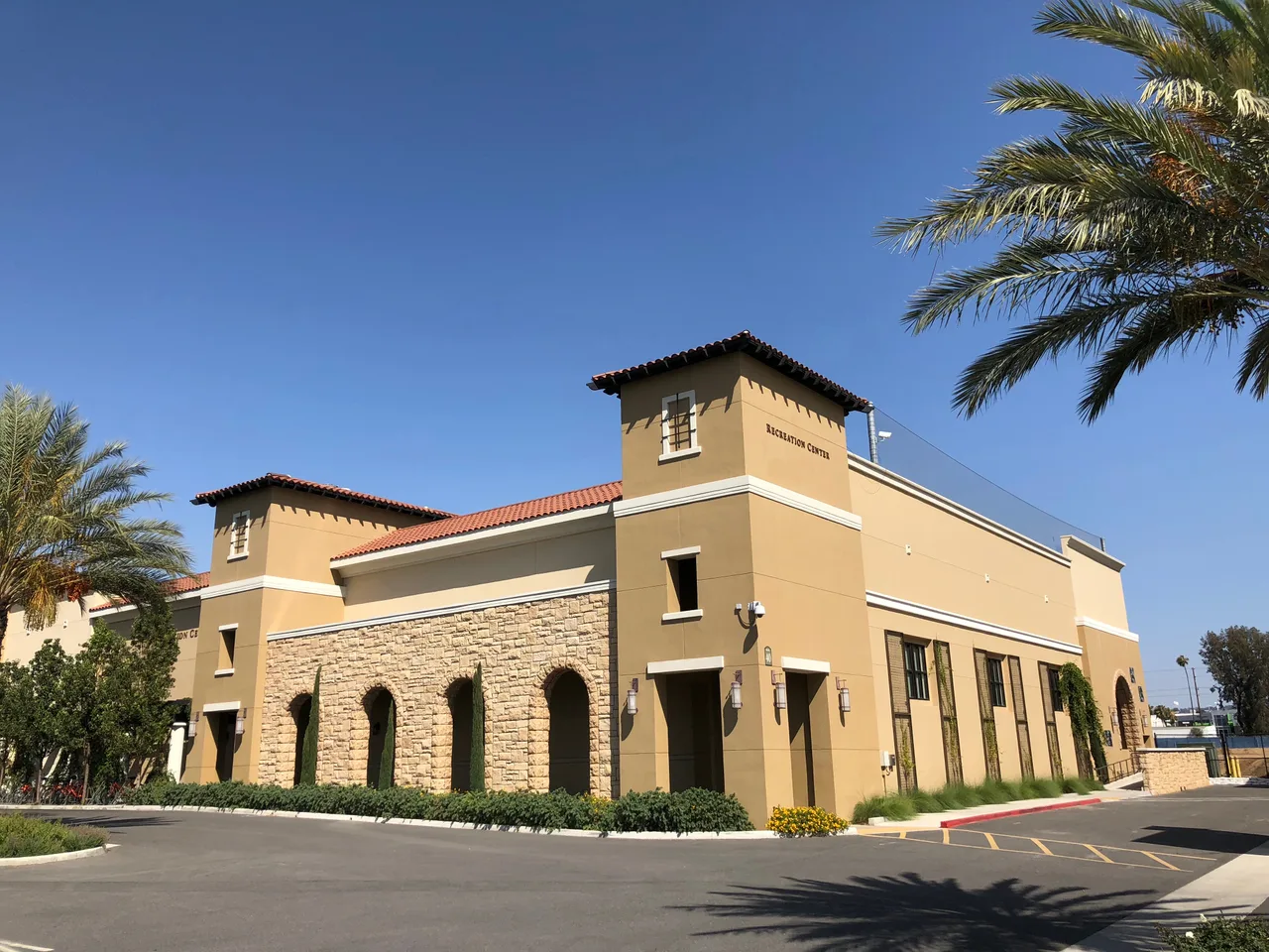 Recreation Center with tiled roofs and palms at California Baptist University in Riverside.