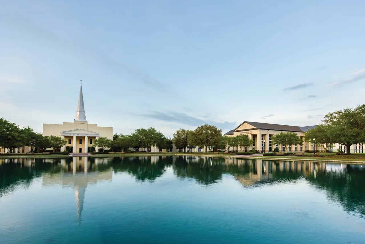Lightsey Chapel and neighboring campus buildings reflected in a pond at Charleston Southern University.