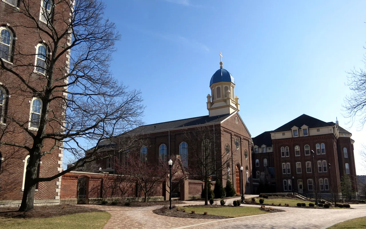 The blue-domed Chapel of the Immaculate Conception and surrounding brick buildings on the University of Dayton campus.
