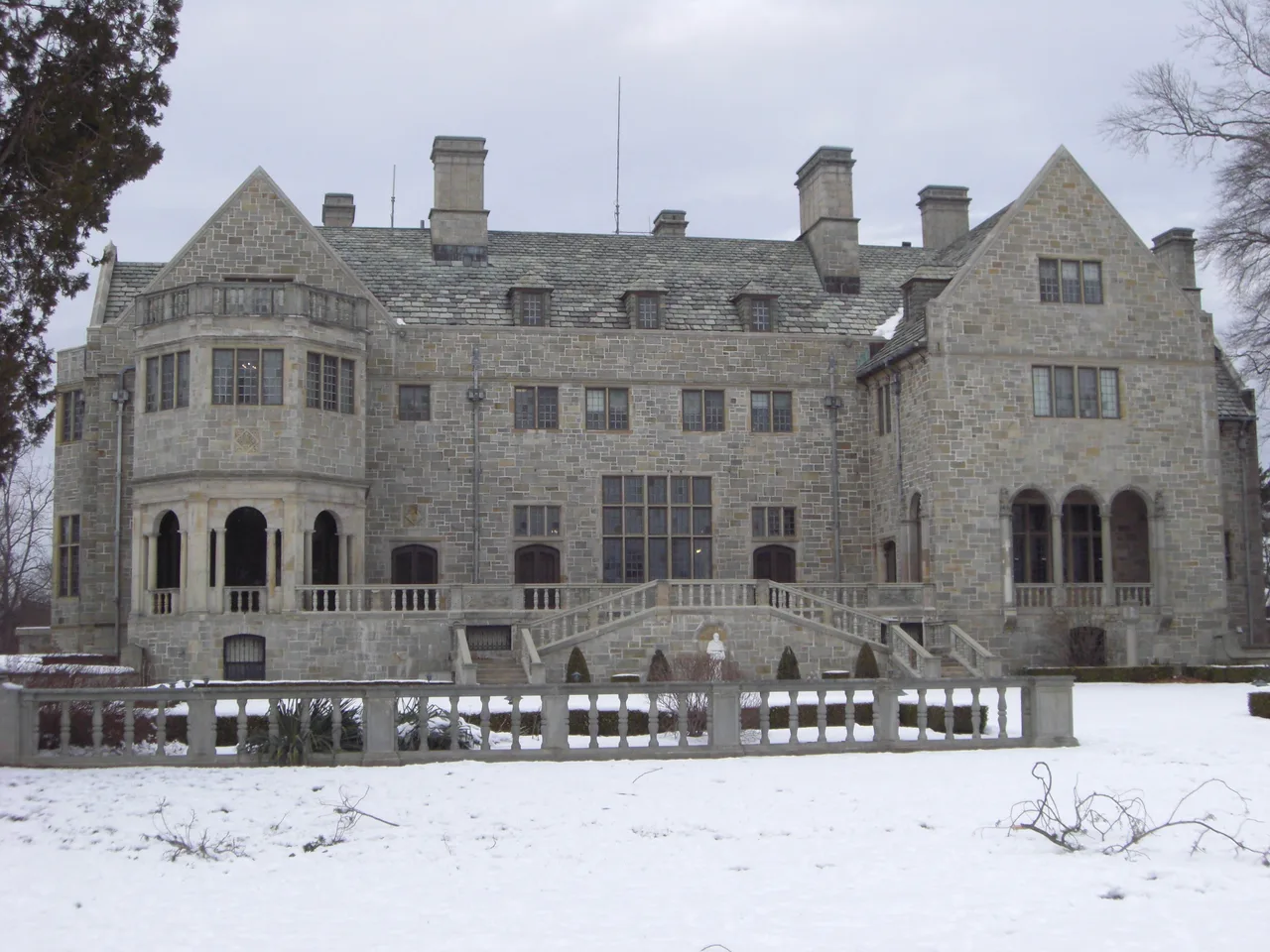 Bellarmine Hall’s stone facade and stairs on Fairfield University’s snowy campus.