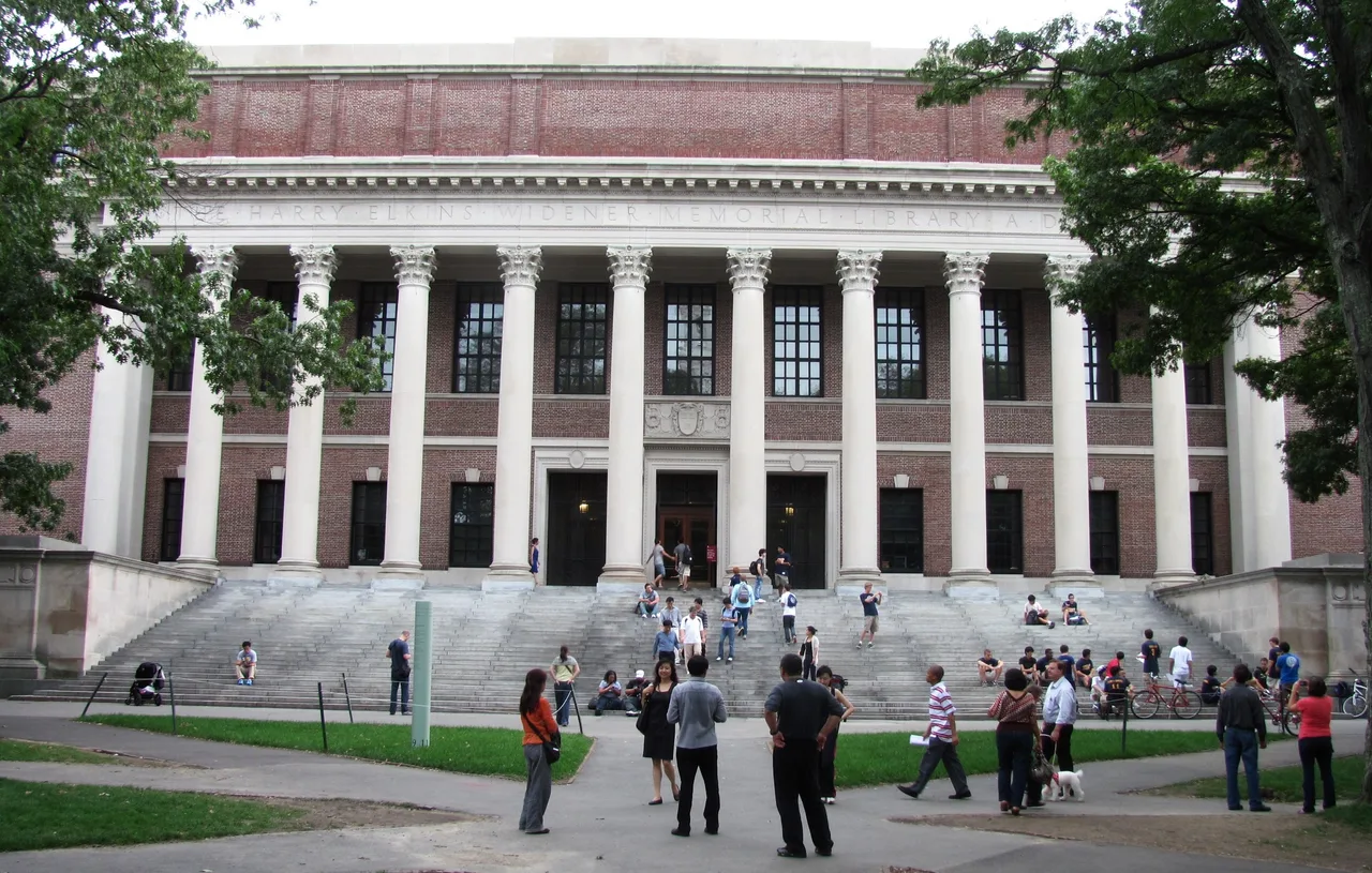 Widener Library’s columned facade and broad steps at Harvard University in Cambridge, with visitors on the steps and trees framing the building.