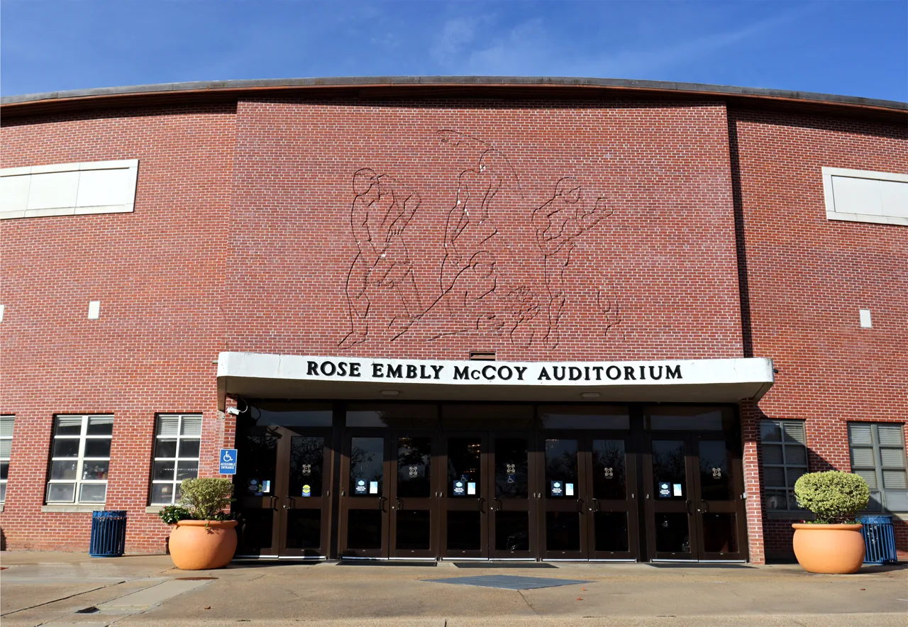 The brick entrance facade and identifying sign of Rose Embly McCoy Auditorium at Jackson State University in Jackson, Mississippi.