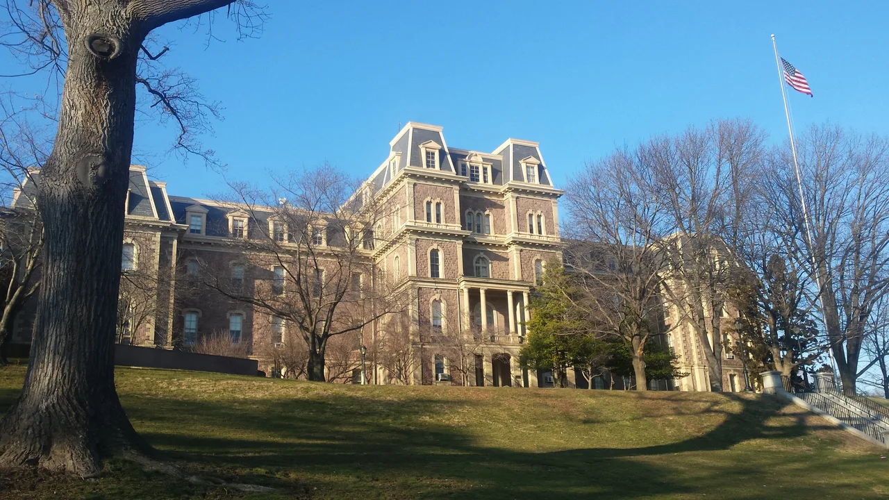 Pardee Hall at Lafayette College in Easton, Pennsylvania, seen across a sloping campus lawn beneath bare trees.
