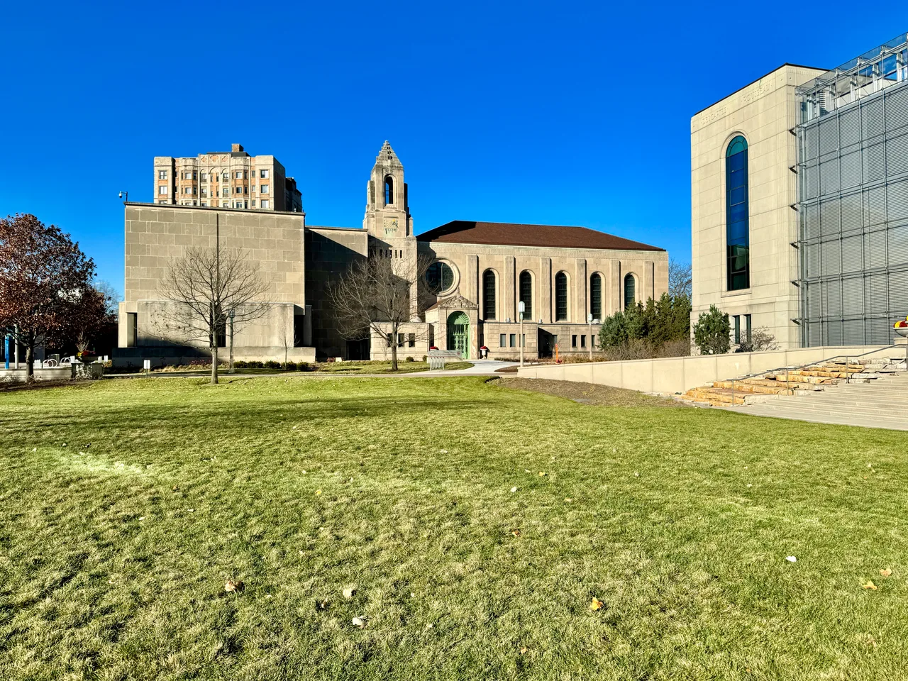 Cudahy Library stone facade and tower behind the lawn at Loyola University Chicago