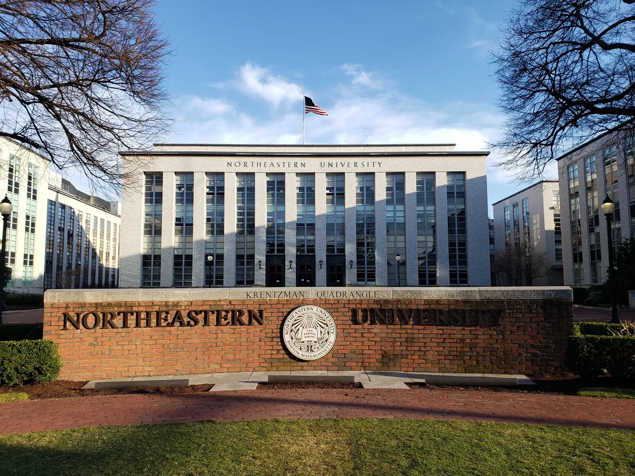 Ell Hall behind the Northeastern University sign at Krentzman Quadrangle on the Boston campus